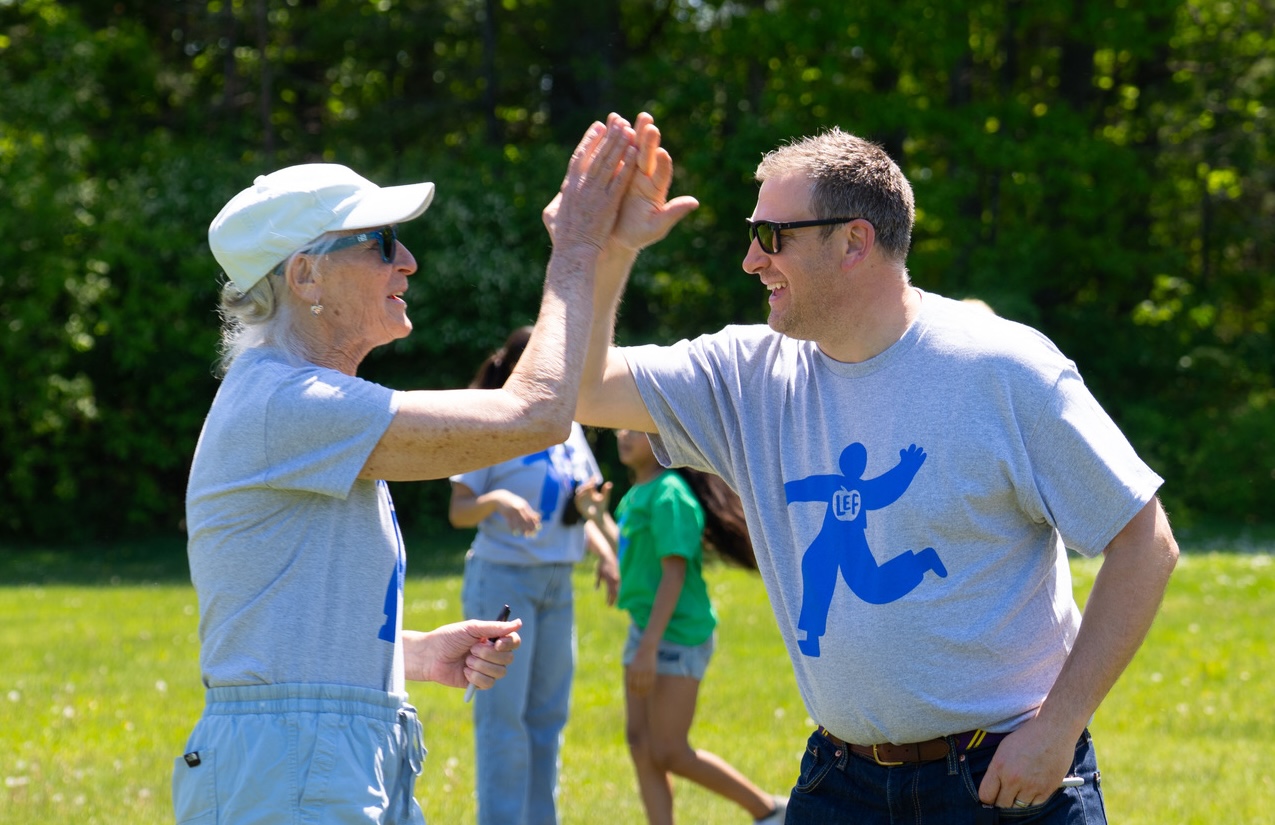 two adults giving a high five